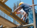 Construction workers placing formwork beams