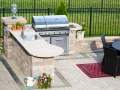 Stylish outdoor kitchen on a brick patio