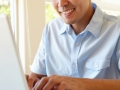 Filipino man working on laptop